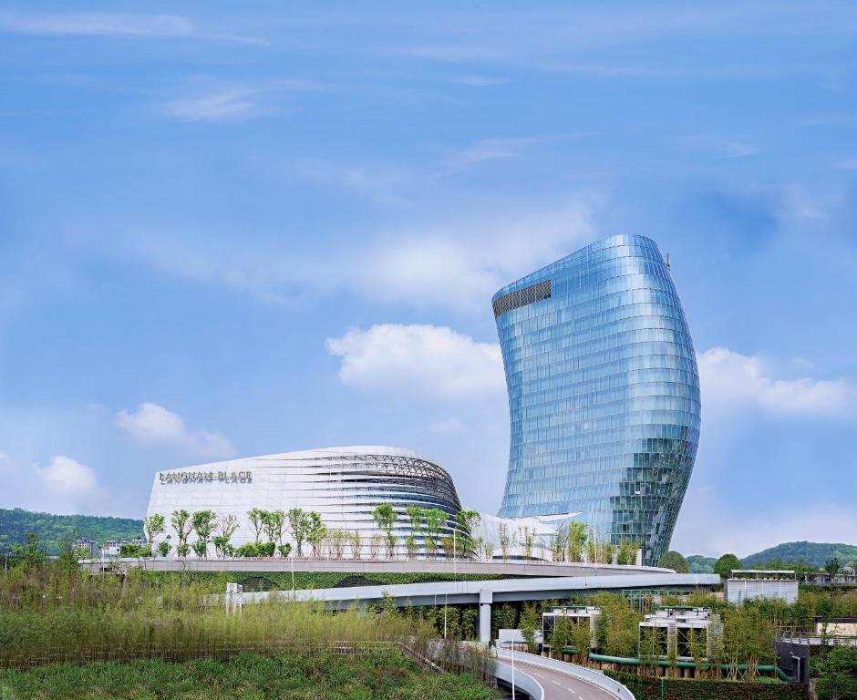 a large glass building with a road in front of it at Langham Place Changsha in Changsha