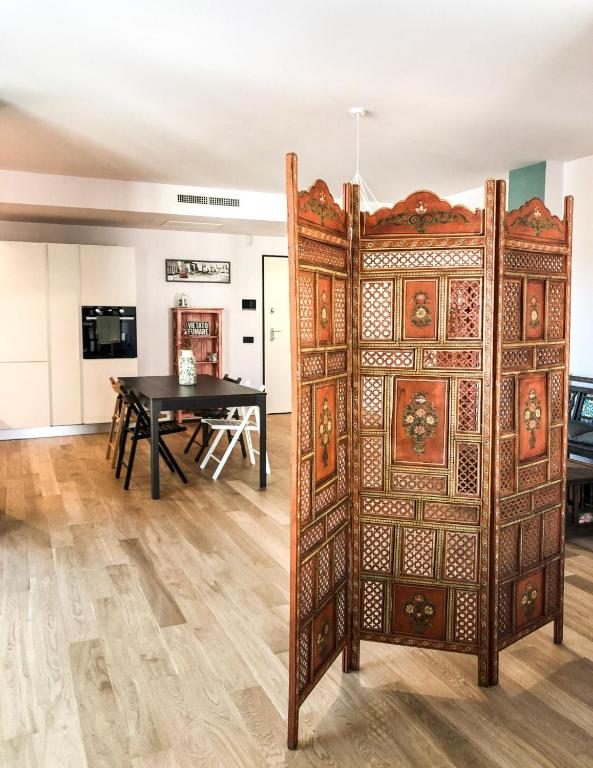 a large wooden door in a room with a table at Casa Rita in Brescia