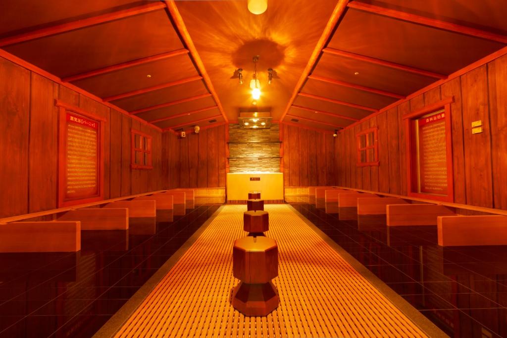 a row of benches in a room with a ceiling at Spa World HOTEL&RESORT in Osaka