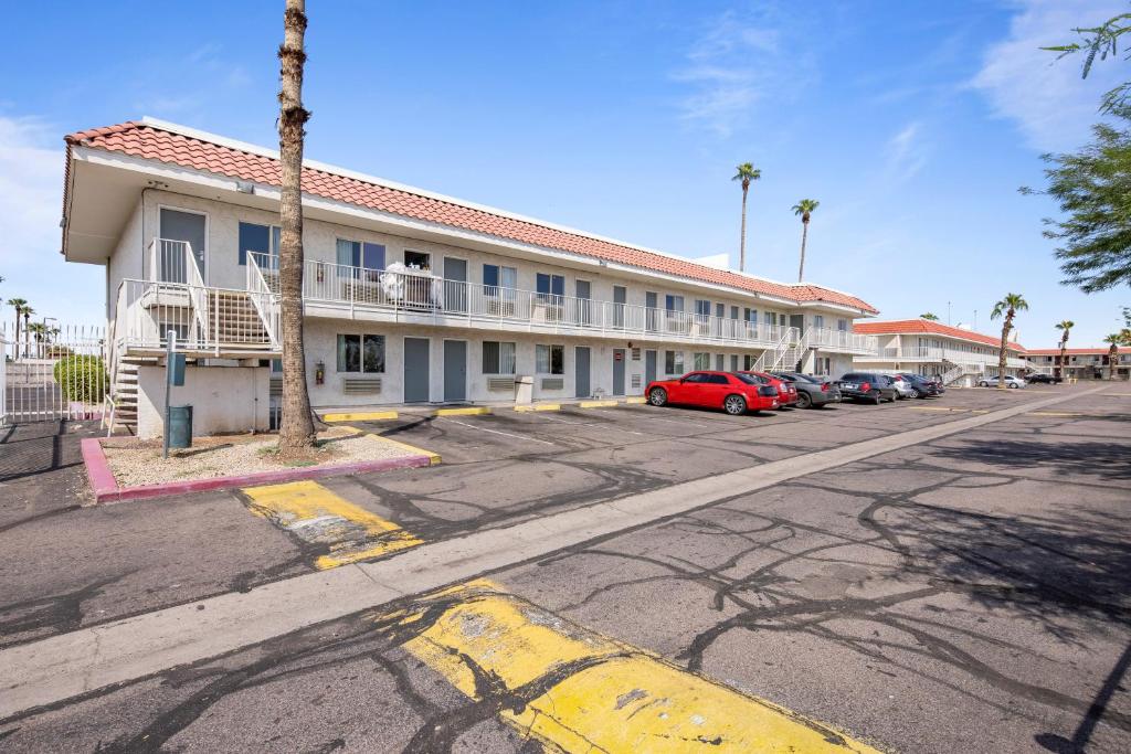 an empty parking lot in front of a hotel at Super 8 by Wyndham Phoenix West in Phoenix