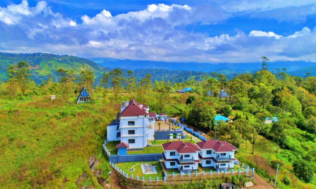 an aerial view of a house on a hill at The Windy Mist Resort Munnar in Chinnakanal