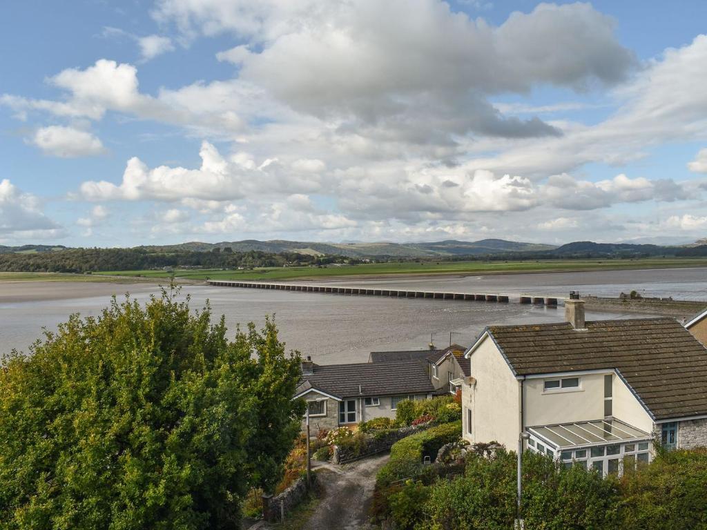 a view of a river with houses and a bridge at Teds Place in Arnside