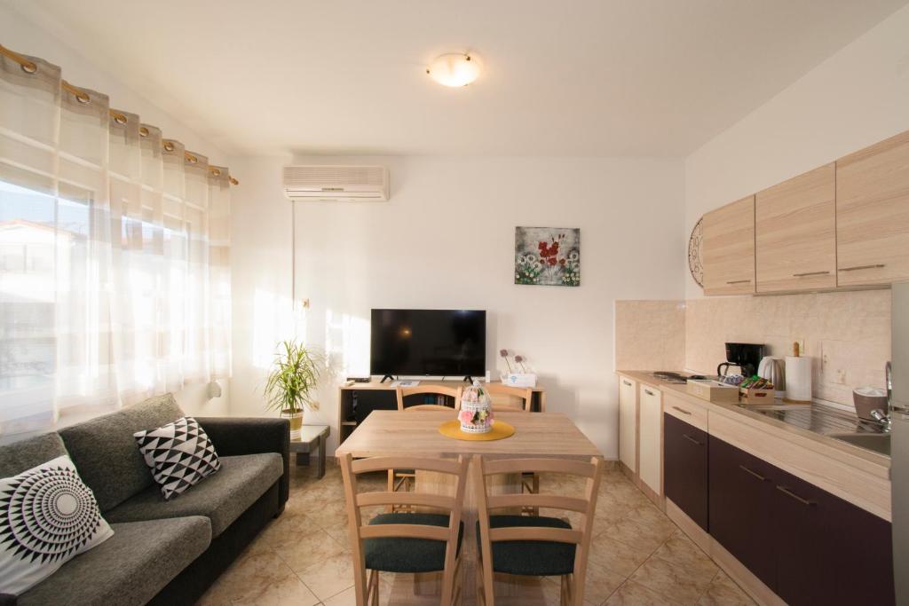 a living room with a couch and a table at Apartman Fuma in Rovinj