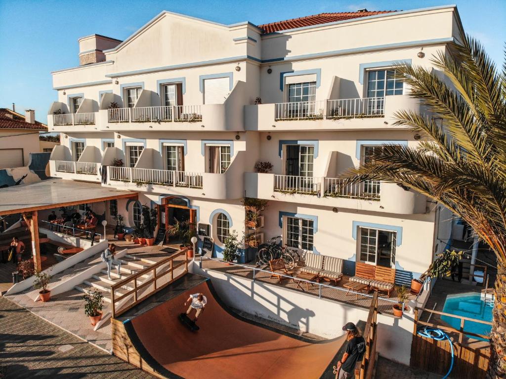 an apartment building with a slide in front of it at Selina Peniche in Peniche