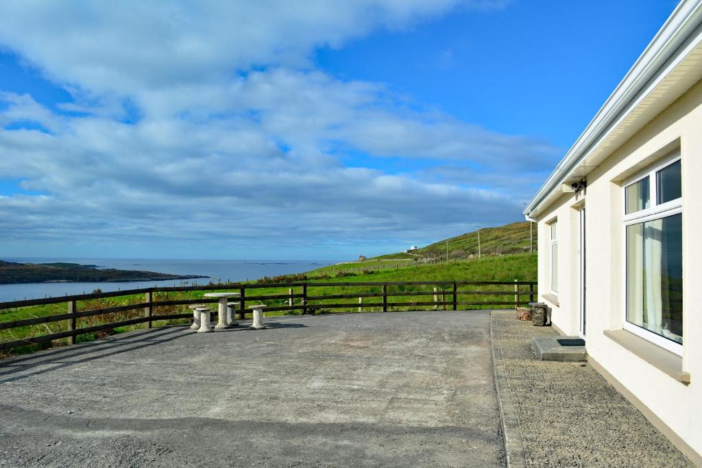 a balcony of a house with a view of the water at Cottage 171 - Clifden in Clifden