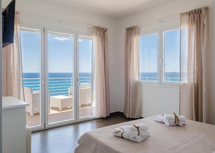 a bedroom with a bed and a view of the ocean at Spuma di mare in Gallipoli