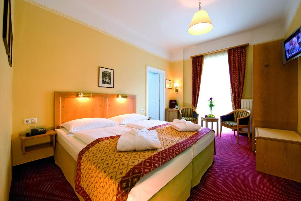 Postel nebo postele na pokoji v ubytování Hotel Gisela