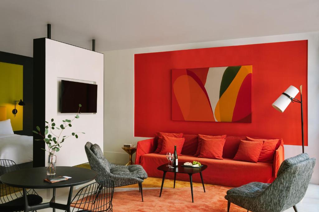 a living room with a red couch and a table at The William powered by Sonder in New York