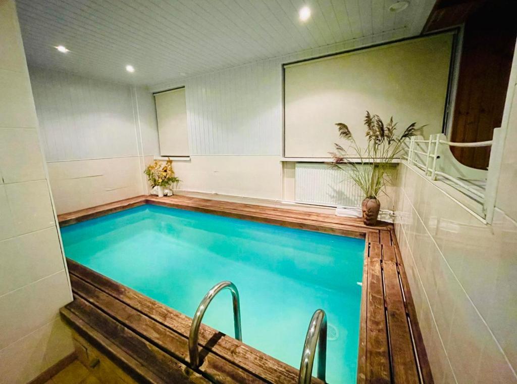 a large swimming pool in a room with at Laine guesthouse in Narva-Jõesuu