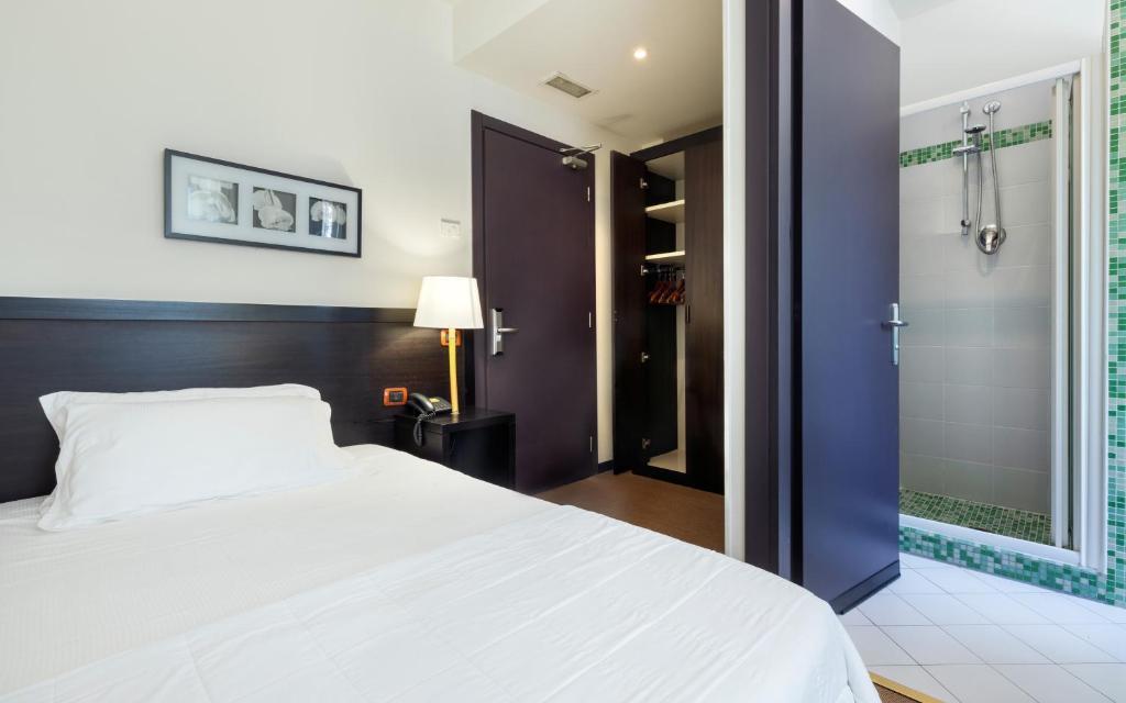 Posteľ alebo postele v izbe v ubytovaní Hotel Mosaico