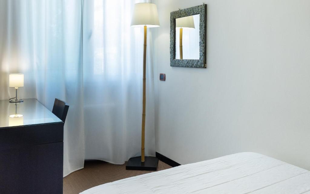 Posteľ alebo postele v izbe v ubytovaní Hotel Mosaico