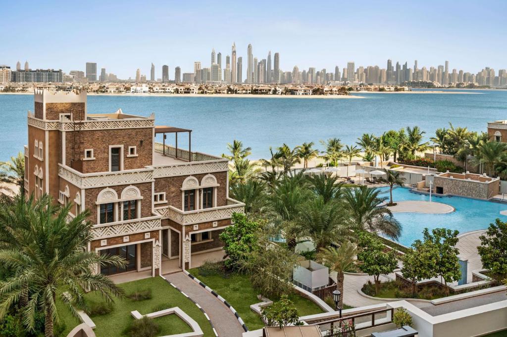 an aerial view of a house with the city in the background at Wyndham Residences The Palm in Dubai