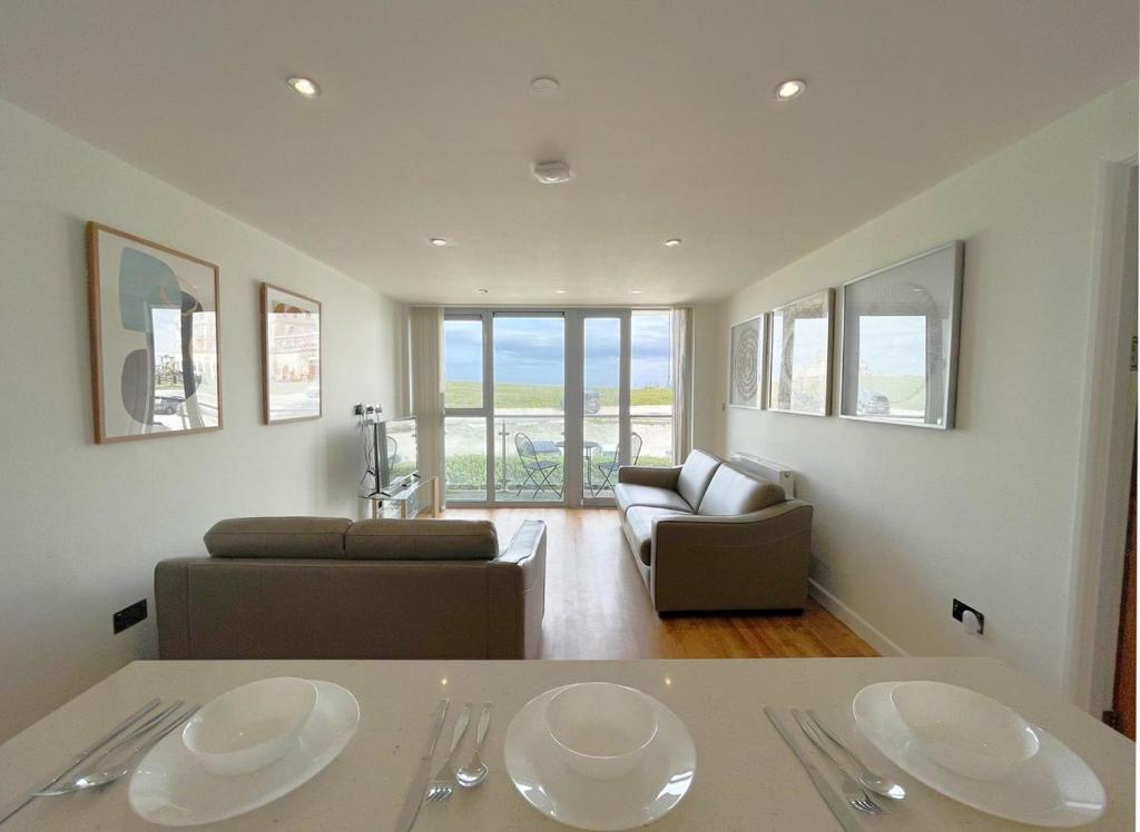 a living room with two white plates on a table at 38 Zinc in Newquay