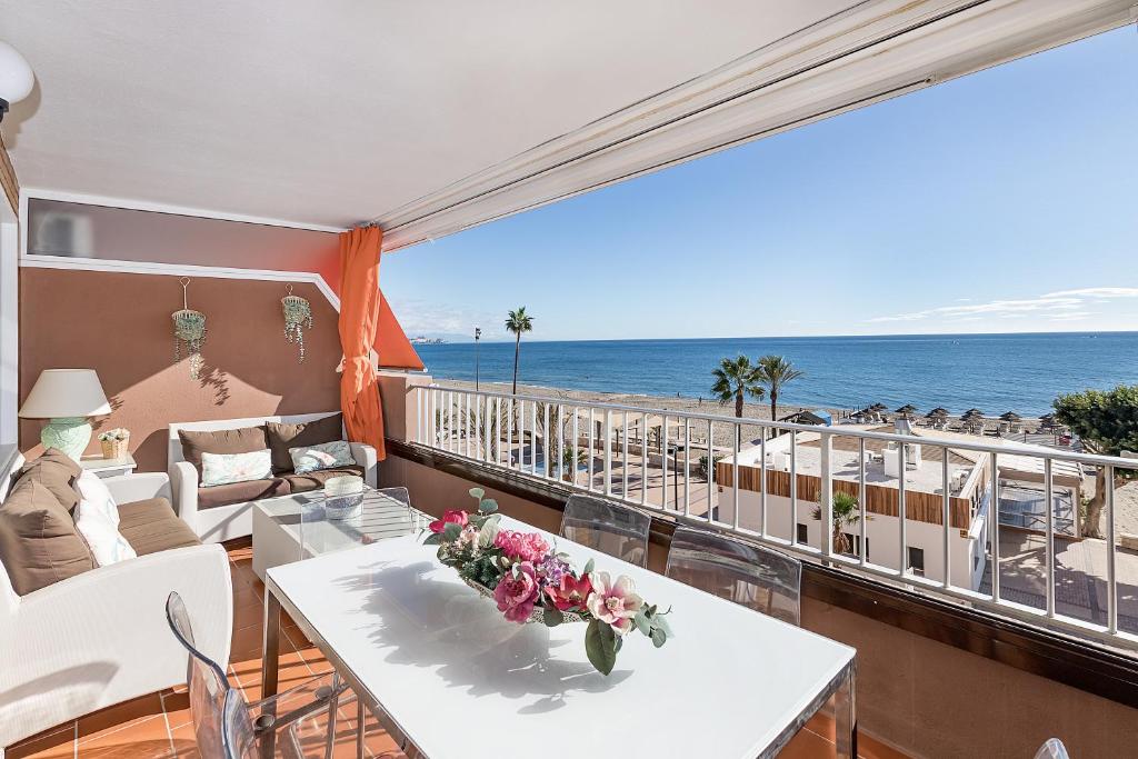 a balcony with a table and a view of the ocean at Bhost - The King in Fuengirola