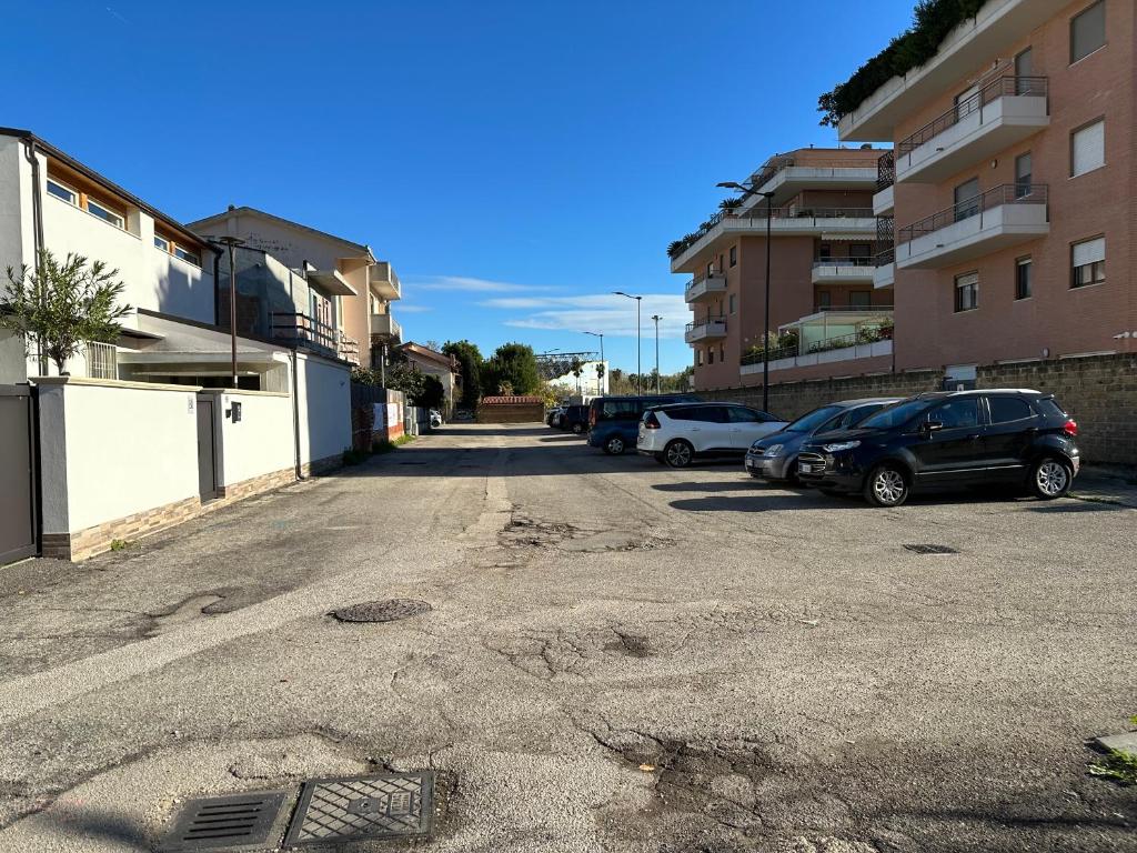 an empty parking lot with cars parked next to buildings at B&B Le Mansarde in Pescara