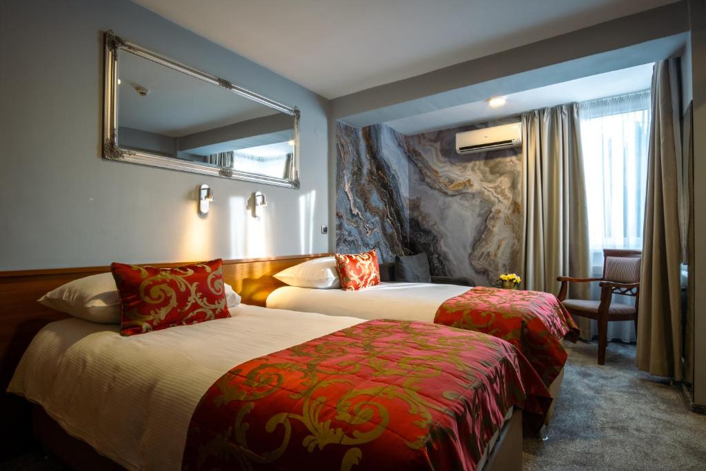 מיטה או מיטות בחדר ב-Hotel Villa Harmony