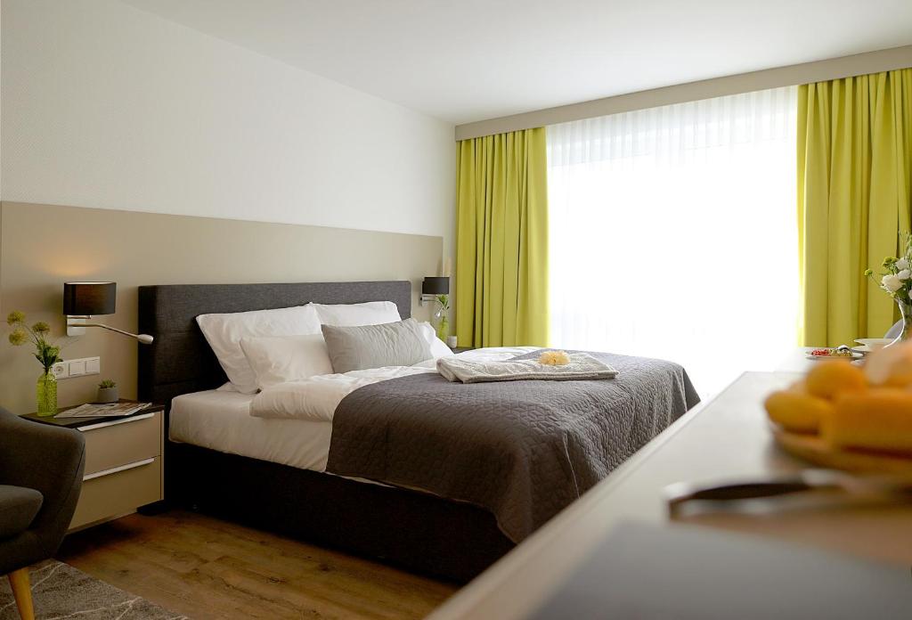 a bedroom with a bed and a window at Gandersheimer Boardinghouse in Bad Gandersheim