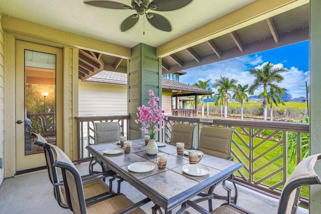 a patio with a table and chairs on a balcony at Pili Mai 1L in Koloa