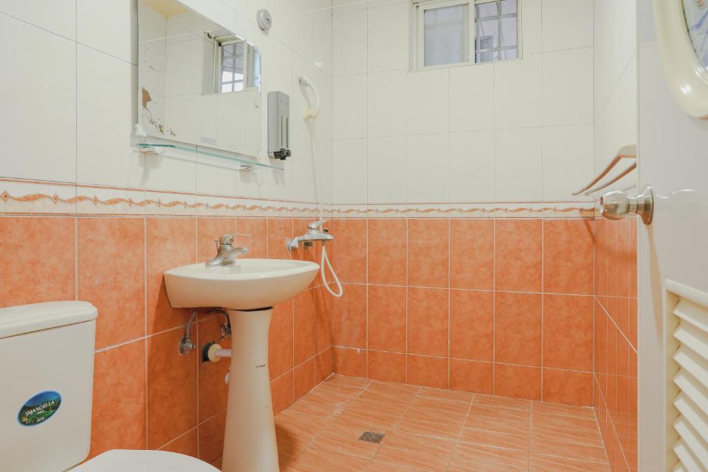e bagno con lavandino, servizi igienici e doccia. di Xing Ji Bungalow a Kenting