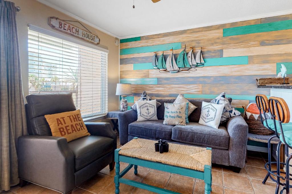ein Wohnzimmer mit einem Sofa und einem Stuhl in der Unterkunft Marvilla Condo My Happy Place in Galveston