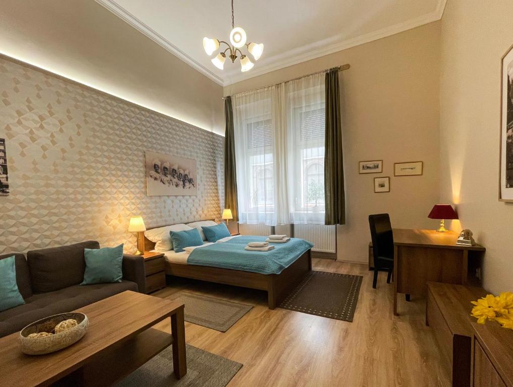 a living room with a couch and a bed at ABT Apartments in Budapest