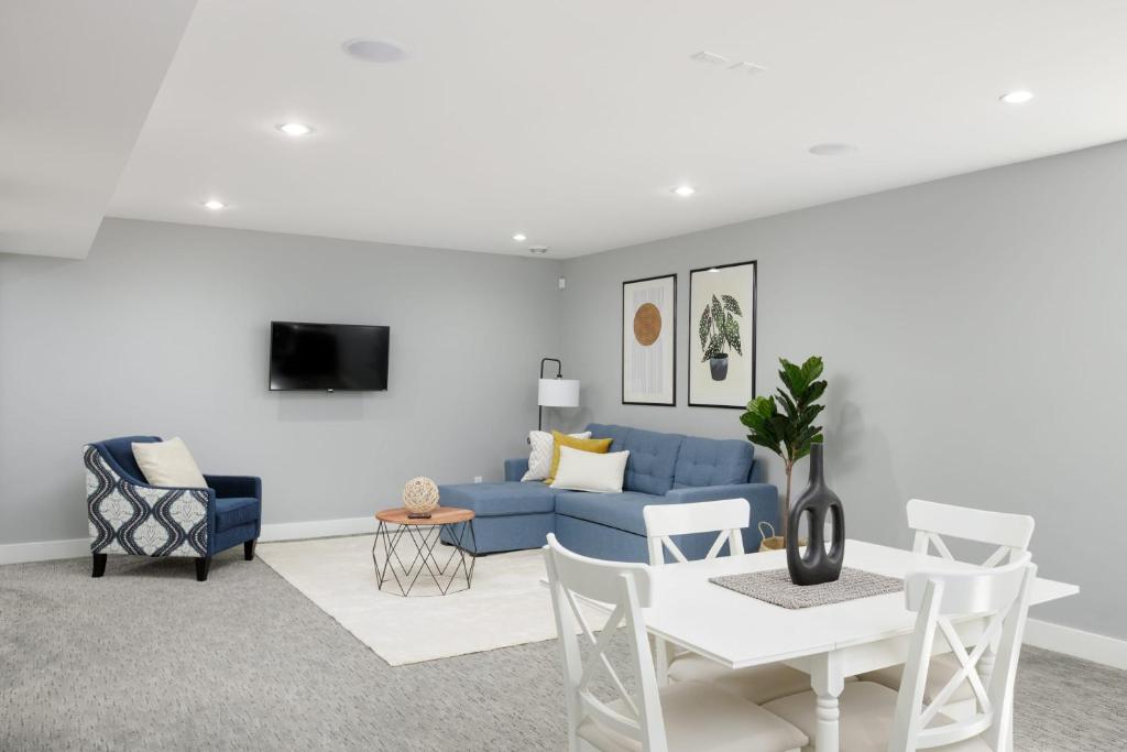 a living room with a blue couch and a table at Bright new 1 BR private secondary basement suite in North Vancouver