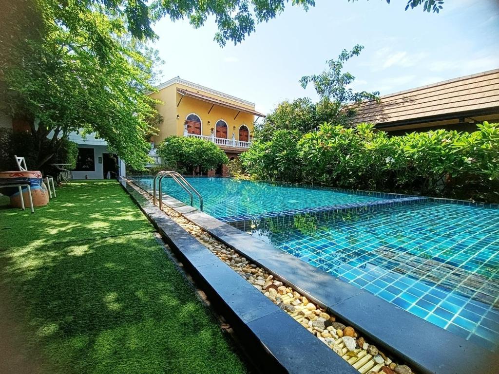 a swimming pool in the yard of a house at Aen Guy Boutique Hotel in Sukhothai