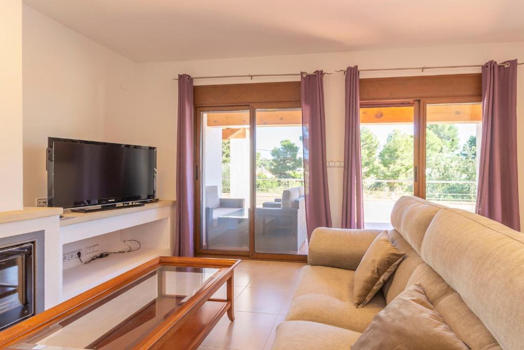 A television and/or entertainment centre at Villa Ampolla II - Costa CarpeDiem