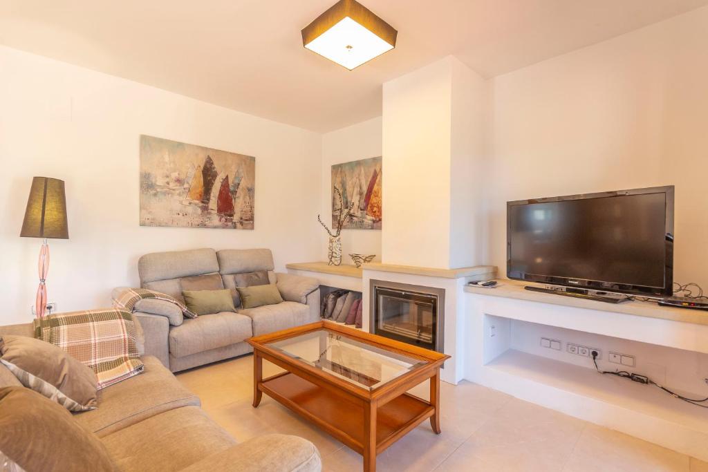 A television and/or entertainment centre at Villa Ampolla II - Costa CarpeDiem