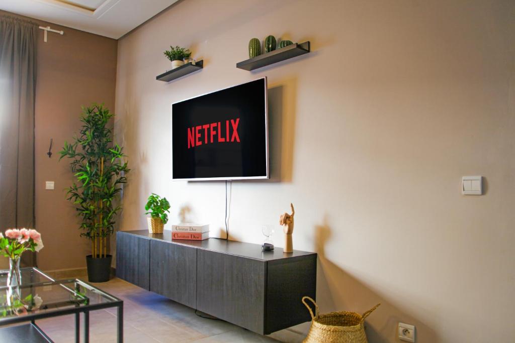 a living room with a television on a wall at YourPlace - 2BR - Agdal - Av France in Rabat