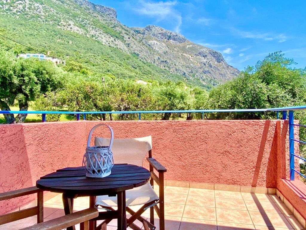 a table with a vase on top of a balcony at Villa Barbati Pelagos with private pool by DadoVillas in Barbati