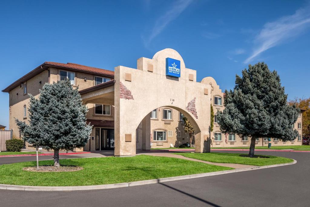 a building with trees in front of it at Americas Best Value Inn Sparks in Sparks