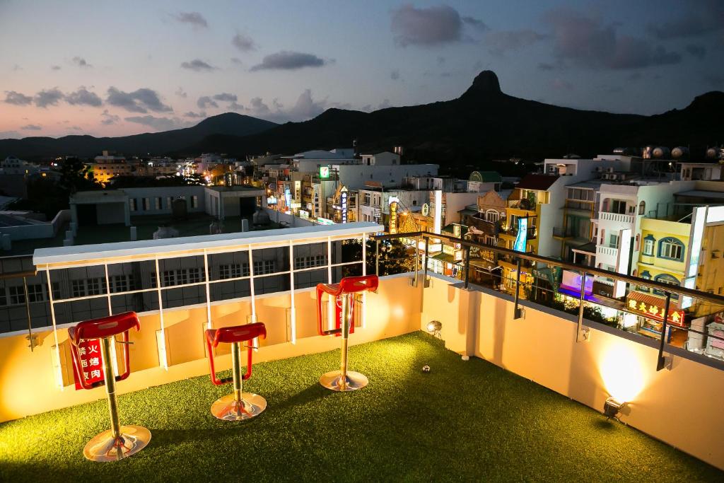 a view of a city from a balcony at night at Bai Sha Tan Cottage in Kenting