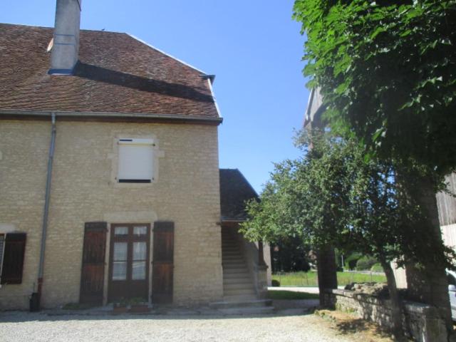 a large brick building with a window and a tree at Appartement La petite Résie in La Résie-Saint-Martin