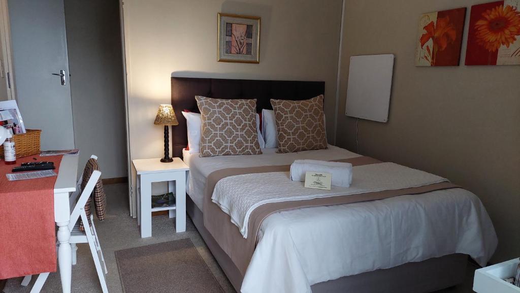 a small bedroom with a bed and a table at King's Hill in Hilton