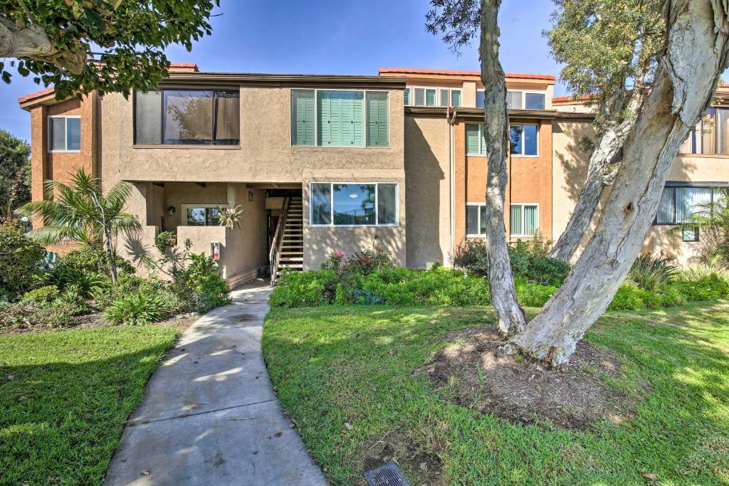 a house with a tree in front of it at Waterfront Huntington Beach Condo with Fire Pit in Huntington Beach