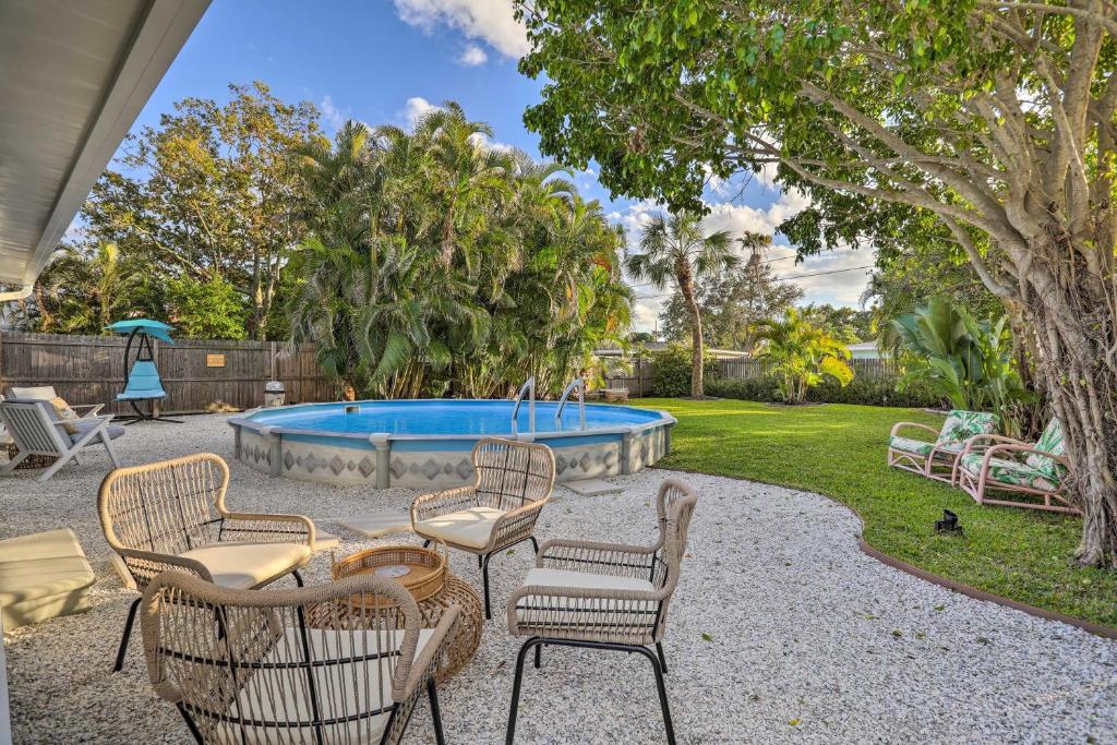 a patio with chairs and a swimming pool at Reddington Beach Oasis with Pool, Walk to Ocean! in St. Pete Beach