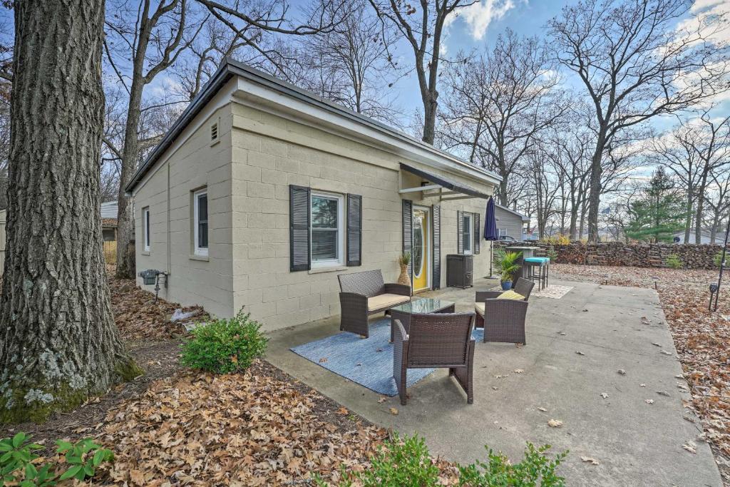 a tiny house with a table and chairs in the yard at Lakeview Mecosta Cottage with Grill and Fire Pit in Mecosta