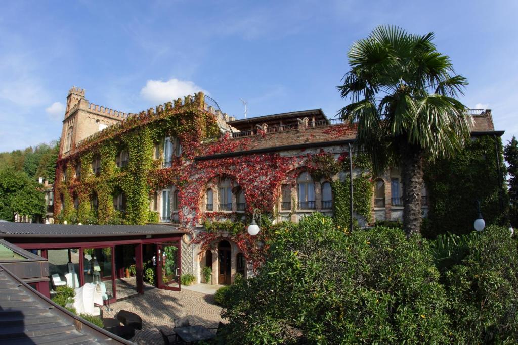 a building covered in ivy with a palm tree at Locanda al Castello Wellness Resort in Cividale del Friuli