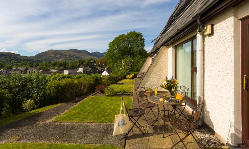 a table and chairs on the side of a house at High Pike in Ambleside