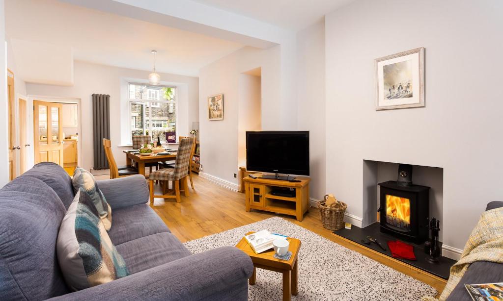 a living room with a couch and a fireplace at Hazel Cottage in Ambleside