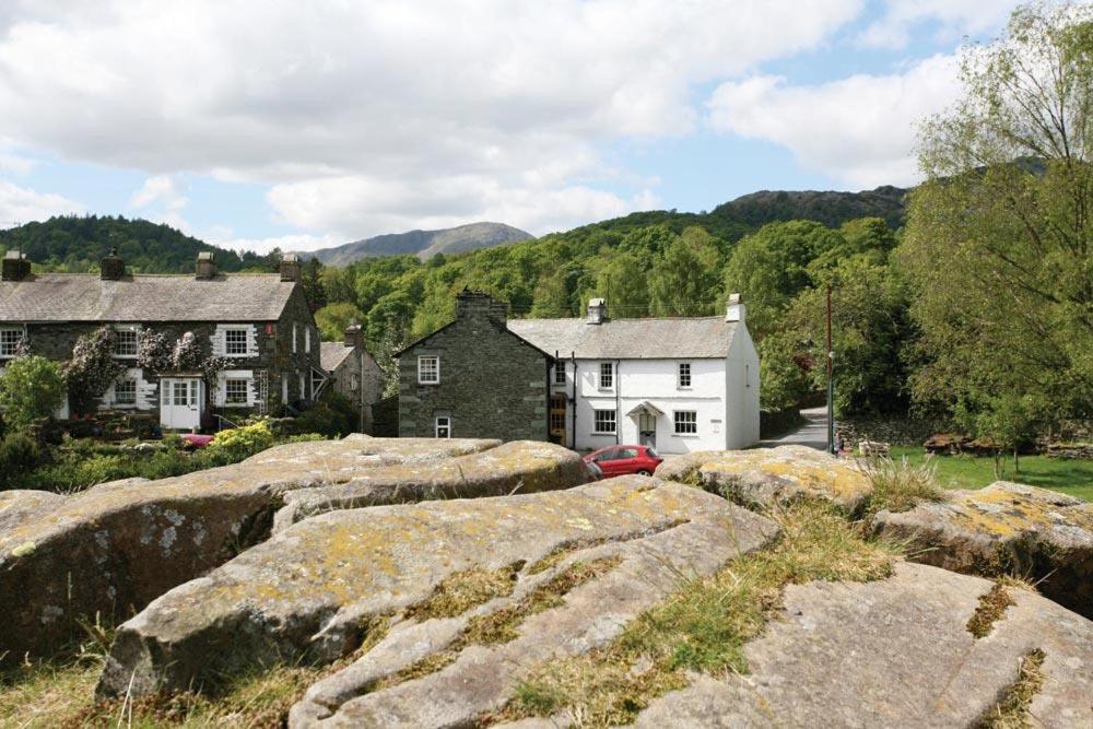 a group of houses with large rocks in front of them at Pollys Cottage in Elterwater