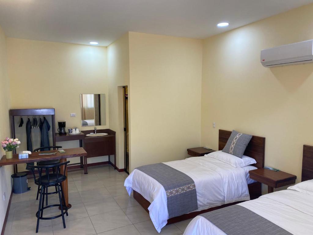 Postel nebo postele na pokoji v ubytování Villa Garita Inn