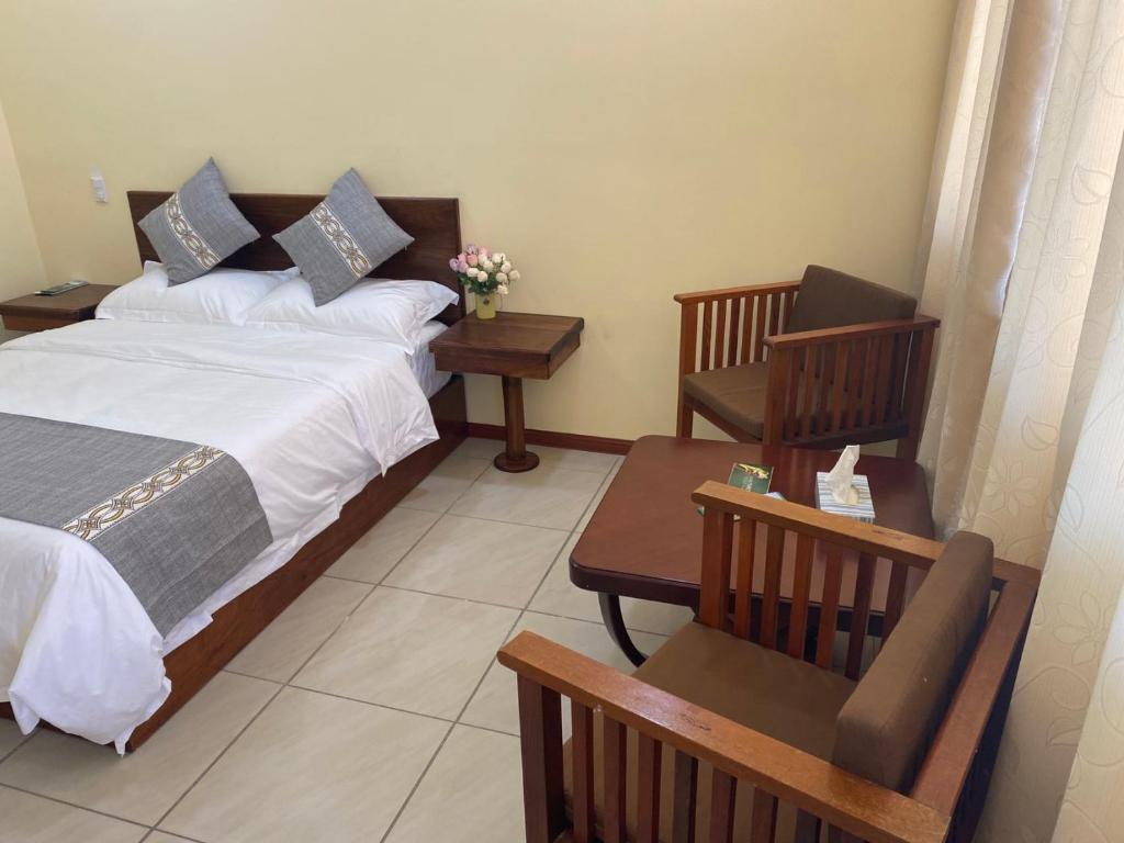 Postel nebo postele na pokoji v ubytování Villa Garita Inn