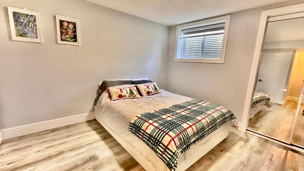 a bedroom with a bed and a window at Cozy Private Suite with Separate Entrance & Free Parking in Calgary