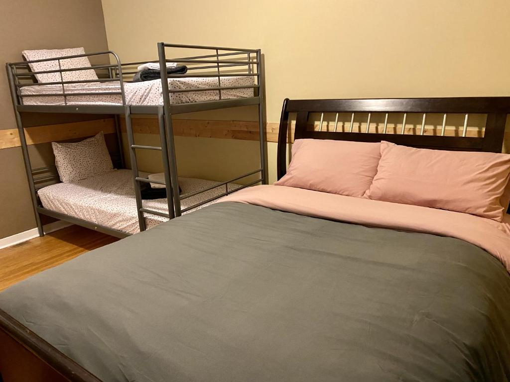 a bedroom with two bunk beds and a bed with a pillow at Auberge du Monde in Trois-Rivières