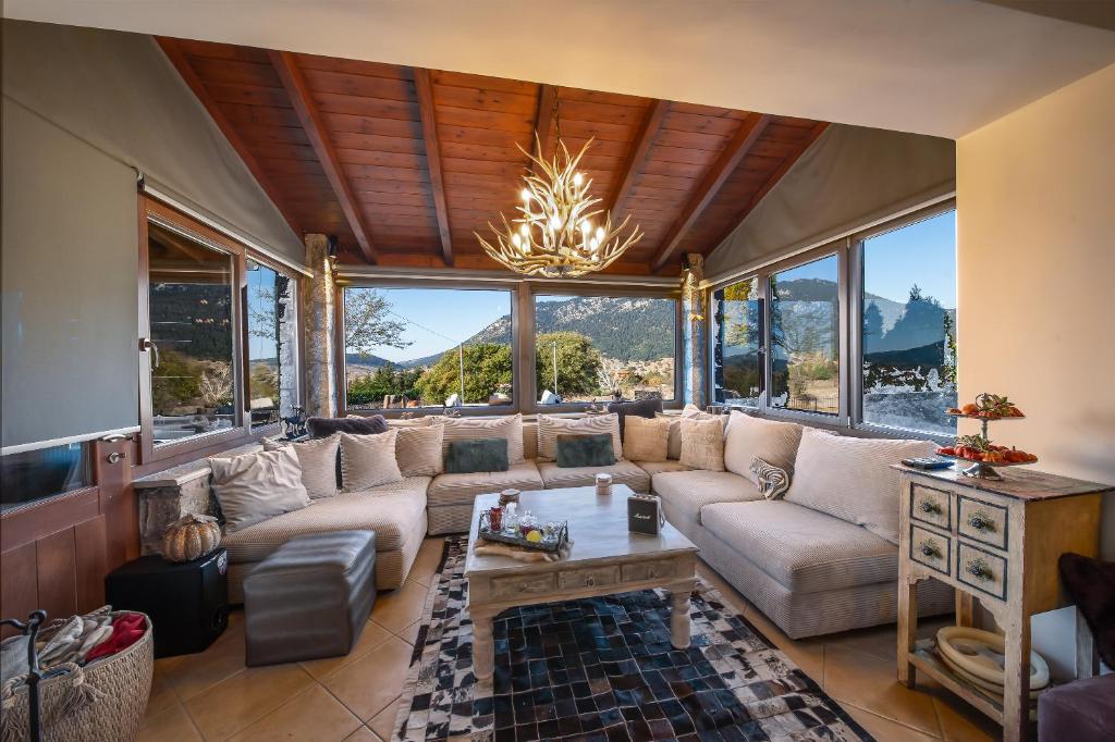 a living room with a couch and a chandelier at Arachova Mountain Villa in Arachova