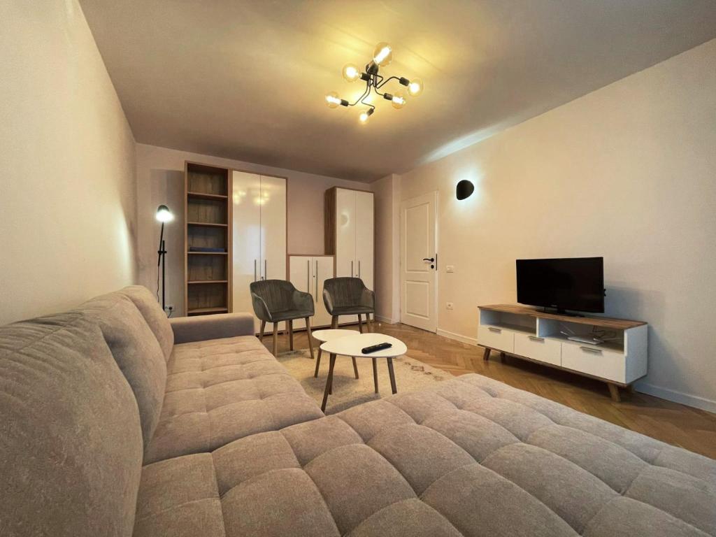 a living room with a couch and a flat screen tv at Apartament Mony in Timişoara