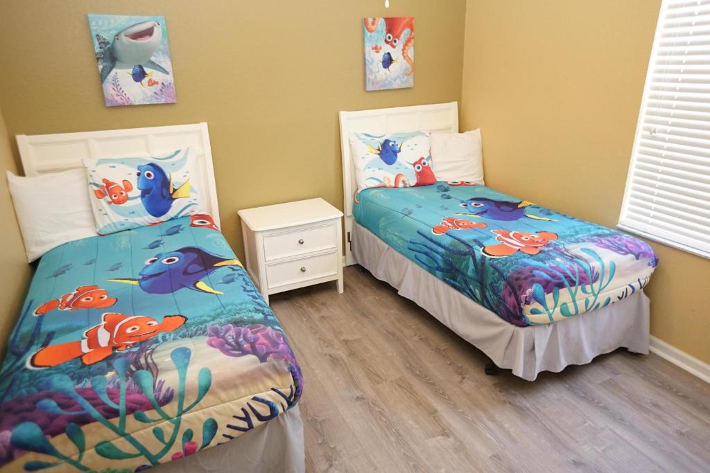 a bedroom with two beds with fish on them at Windsor Hills Resort- 401 in Orlando