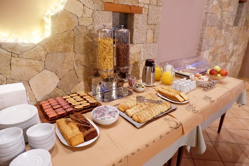 a table with a bunch of food on it at Lilea's Castle in Lílaia